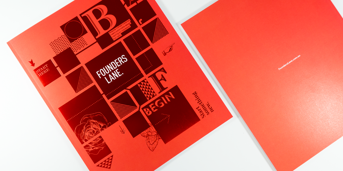 Top down flatly of 'Founders Lane' brochure, front and back red covers with foil