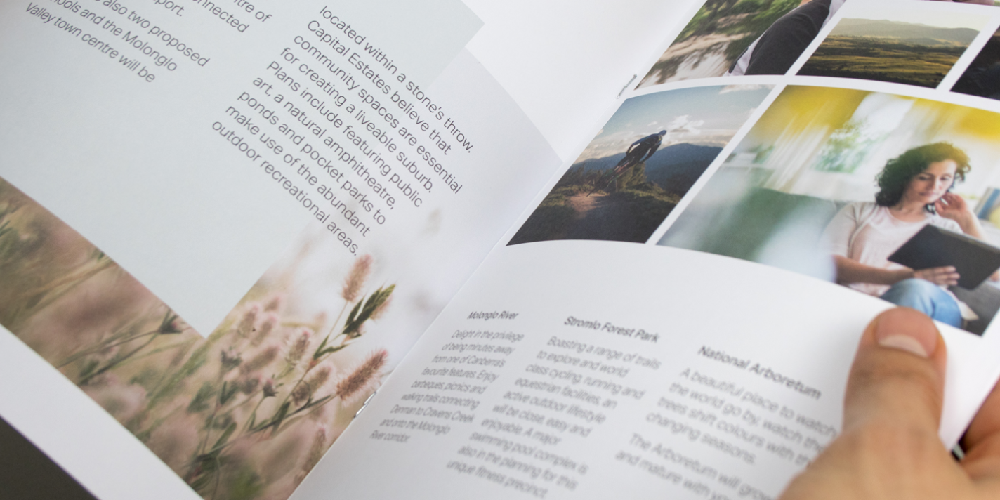 Close up of someone holding an open Denman Prospect brochure.