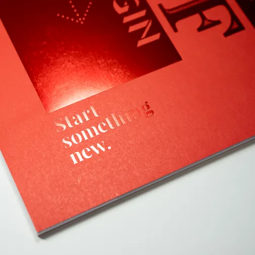 A close up of the Founders Lane brochure's red cover and foiled text 'Start something new'